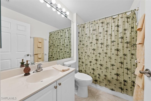 bathroom featuring toilet, vanity, shower / bath combo with shower curtain, and tile patterned floors