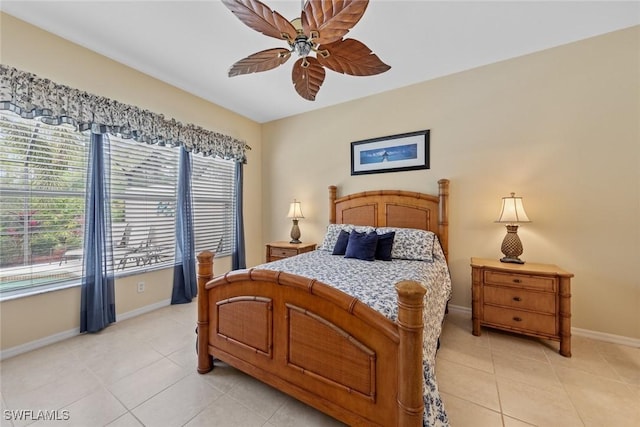 bedroom with light tile patterned floors, baseboards, and a ceiling fan