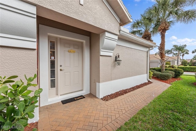 property entrance featuring stucco siding