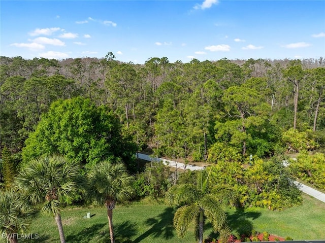 birds eye view of property featuring a view of trees