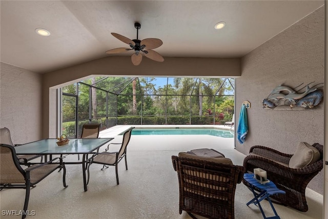 view of patio featuring glass enclosure, an outdoor pool, and ceiling fan