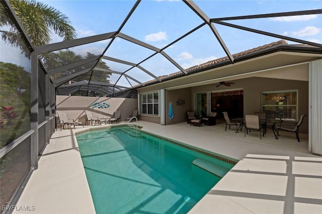 view of swimming pool featuring a fenced in pool, a ceiling fan, glass enclosure, a patio area, and outdoor lounge area