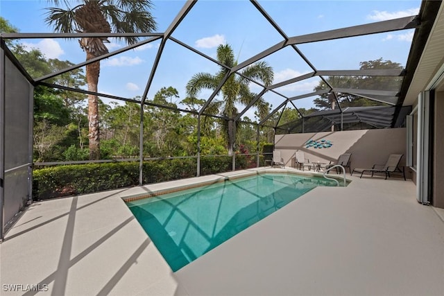 outdoor pool with a lanai and a patio area