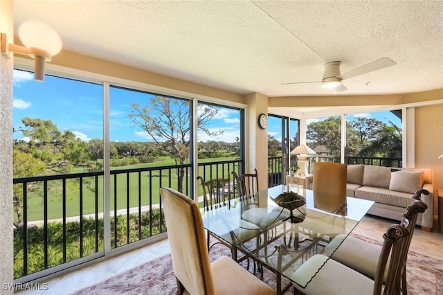 sunroom featuring ceiling fan