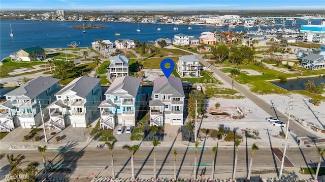 birds eye view of property featuring a water view and a residential view