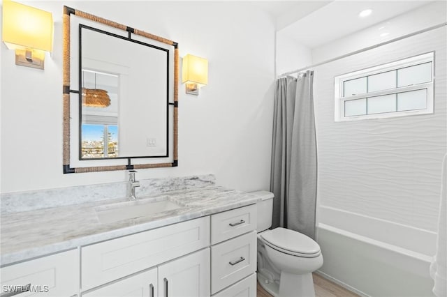 full bathroom featuring shower / bath combo with shower curtain, vanity, and toilet