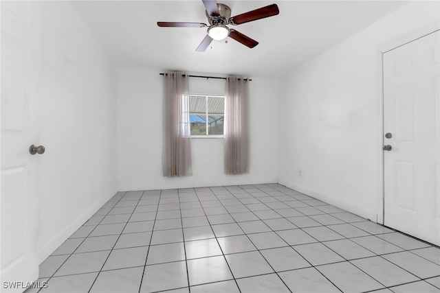 unfurnished room with light tile patterned floors and ceiling fan