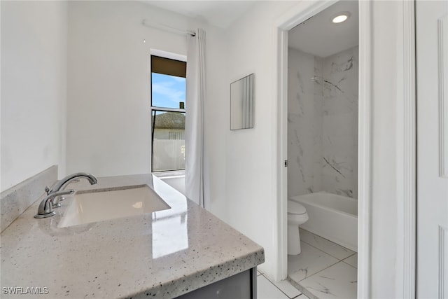 full bath featuring toilet, marble finish floor,  shower combination, and vanity