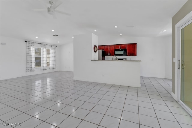 unfurnished living room with lofted ceiling, light tile patterned floors, a ceiling fan, and recessed lighting