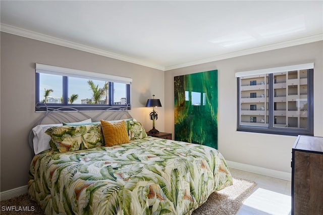 bedroom with ornamental molding and baseboards