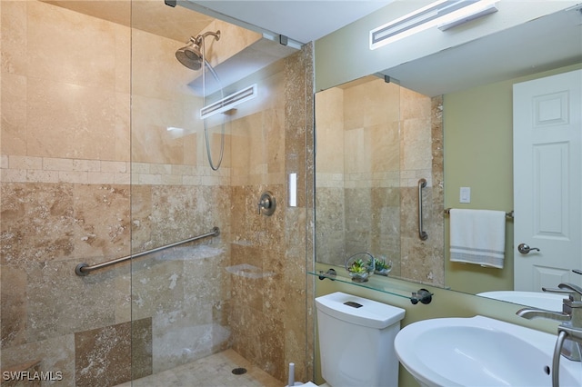 full bathroom with toilet, a tile shower, and a sink