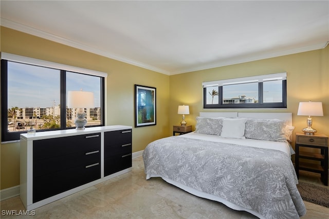 bedroom featuring ornamental molding, multiple windows, and baseboards