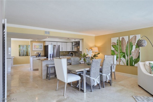 dining room with ornamental molding, visible vents, and baseboards