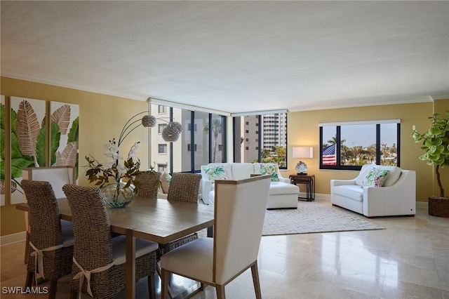 dining space featuring crown molding and baseboards