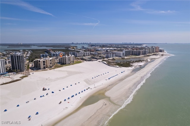 drone / aerial view featuring a view of city, a beach view, and a water view