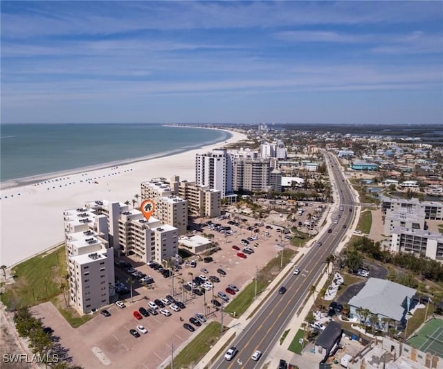 birds eye view of property with a water view, a beach view, and a city view