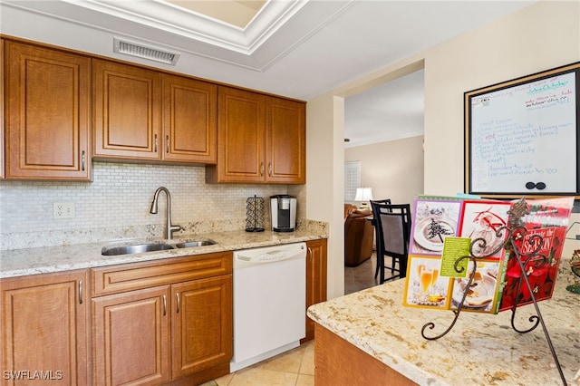 kitchen featuring visible vents, dishwasher, a sink, and light stone countertops