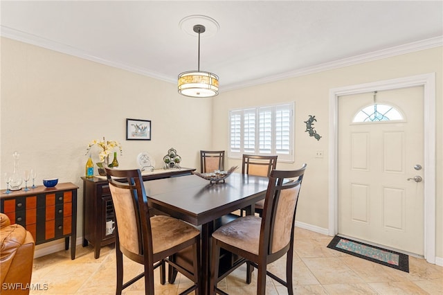 dining space featuring ornamental molding and baseboards