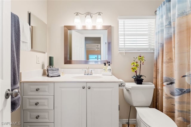 full bath featuring toilet, a shower with shower curtain, and vanity