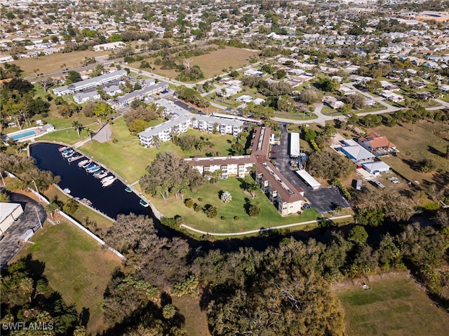 drone / aerial view featuring a residential view and a water view