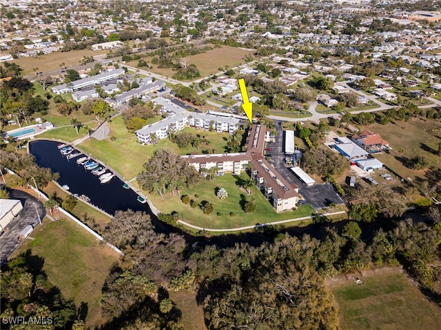 birds eye view of property featuring a water view and a residential view