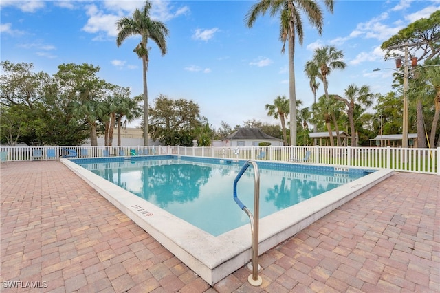 community pool featuring a patio area and fence