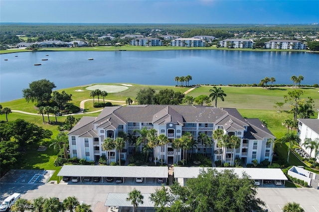 aerial view with view of golf course, a water view, and a residential view