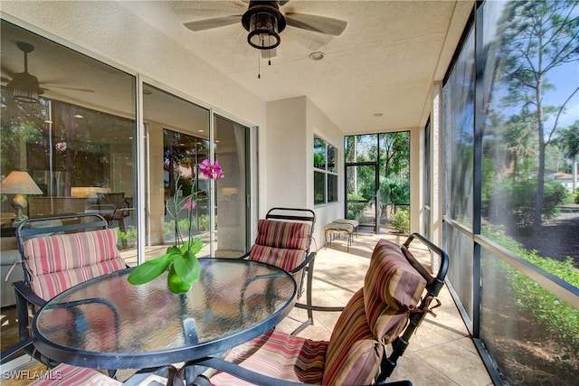 sunroom / solarium featuring ceiling fan