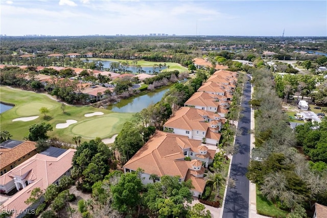 bird's eye view with golf course view, a water view, and a residential view