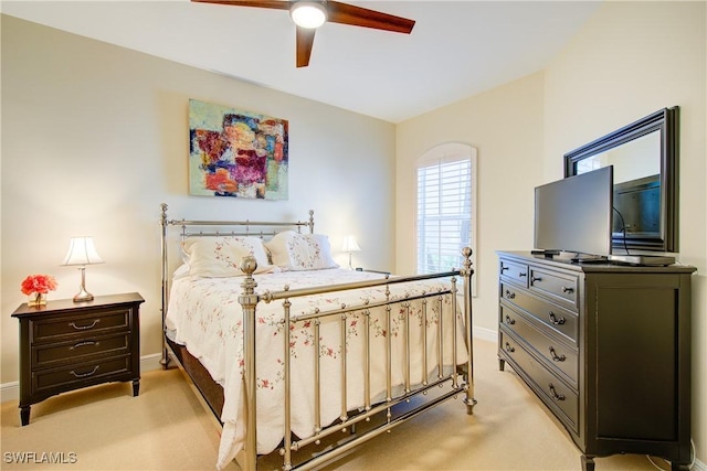 bedroom featuring ceiling fan, baseboards, and light colored carpet