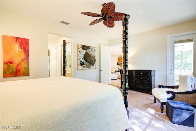 bedroom featuring a ceiling fan, visible vents, and light colored carpet