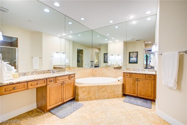 full bathroom with tile patterned floors, two vanities, a shower stall, and a bath