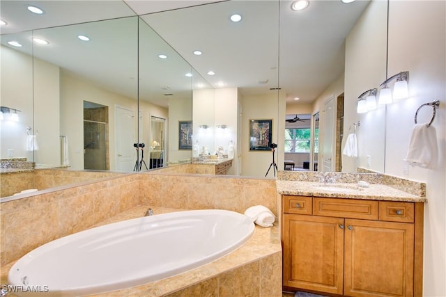 bathroom featuring recessed lighting, a garden tub, vanity, and a shower stall