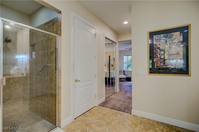 bathroom featuring recessed lighting, a shower stall, baseboards, and tile patterned floors