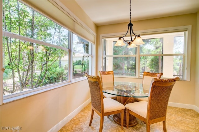 dining space with light tile patterned floors, baseboards, and an inviting chandelier