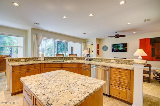 kitchen featuring a sink, a kitchen island with sink, visible vents, and dishwasher