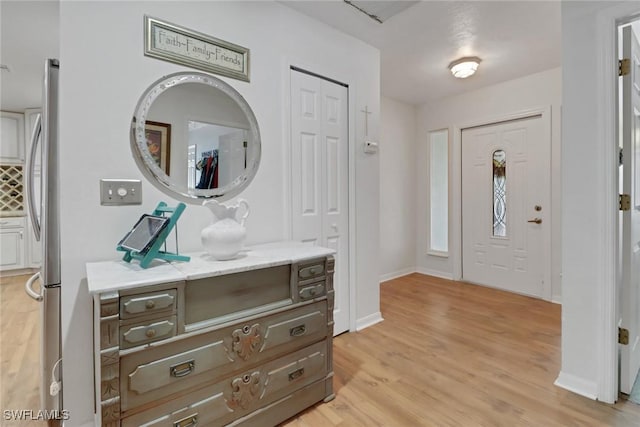 entrance foyer featuring light wood-style floors and baseboards