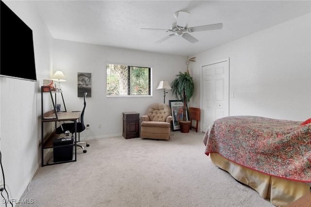 carpeted bedroom with a ceiling fan and baseboards