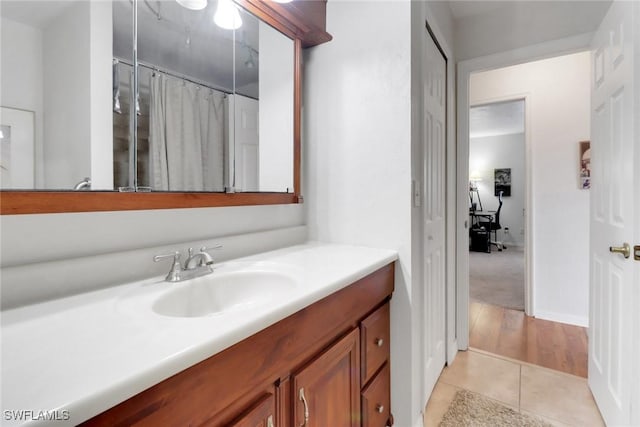 full bathroom with curtained shower, tile patterned flooring, and vanity