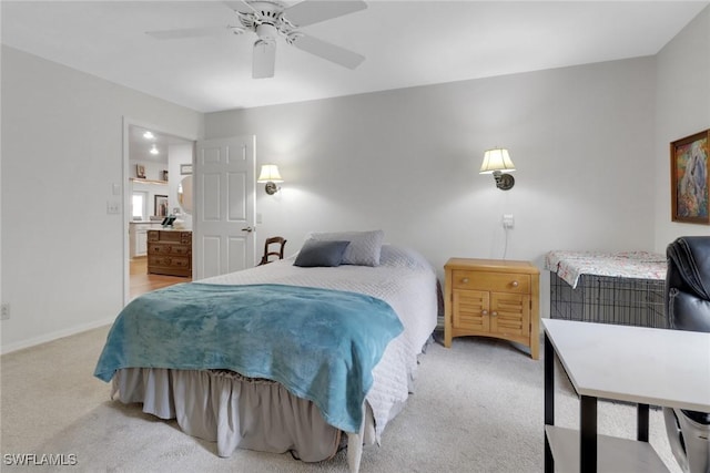 bedroom with light carpet, connected bathroom, and a ceiling fan