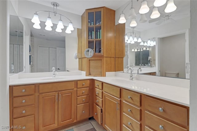 full bathroom featuring a closet, a sink, toilet, and double vanity