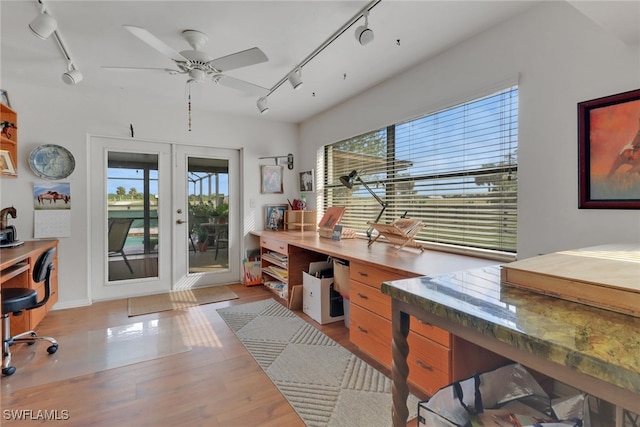 home office with light wood-type flooring, a ceiling fan, track lighting, and french doors