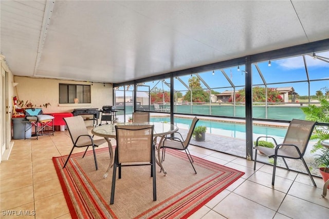 sunroom featuring a swimming pool