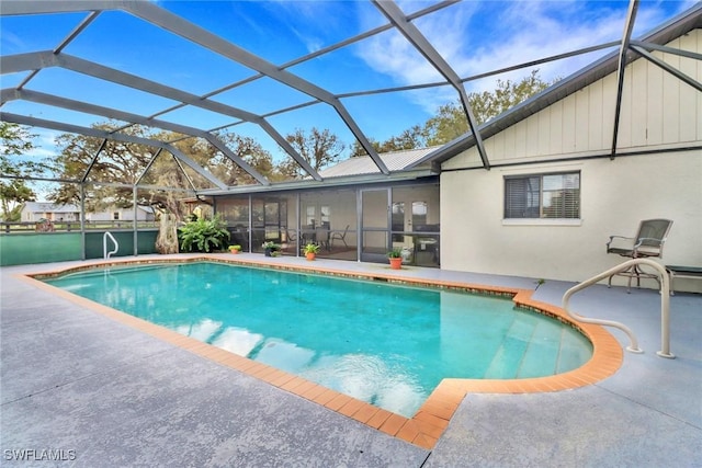 outdoor pool featuring a patio area and glass enclosure