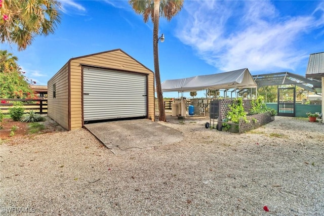 detached garage featuring fence