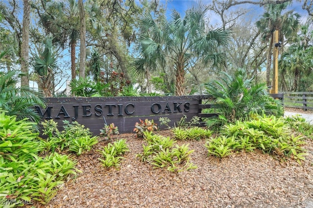 community / neighborhood sign featuring fence