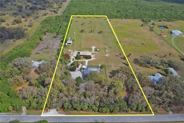 birds eye view of property with a rural view