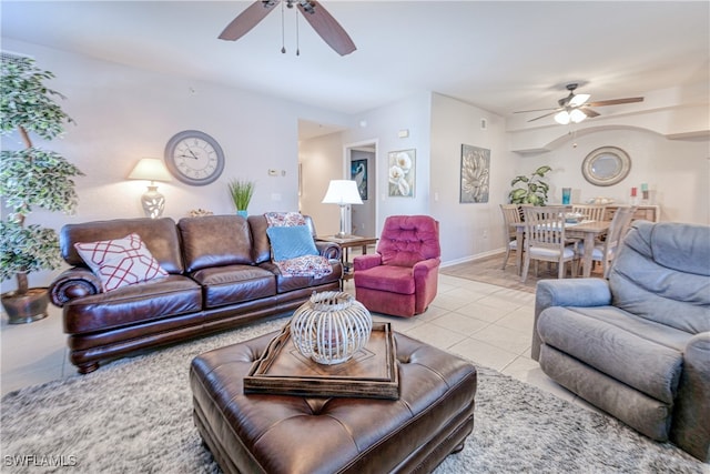 living room featuring light tile patterned floors, ceiling fan, and baseboards