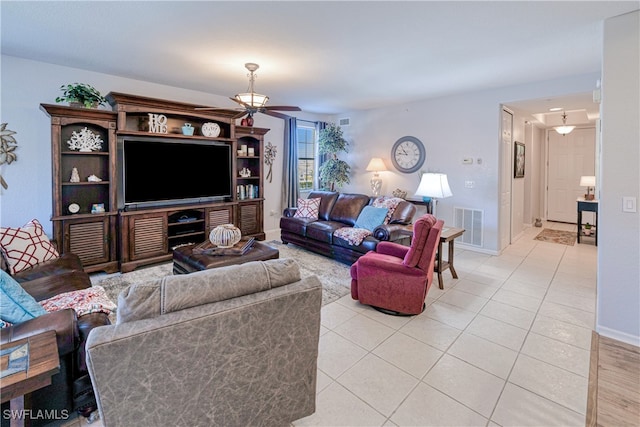 living area featuring light tile patterned floors, baseboards, and visible vents