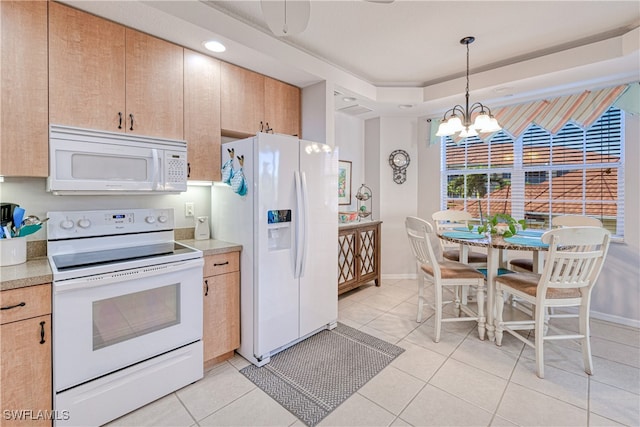 kitchen featuring white appliances, light tile patterned floors, light countertops, and decorative light fixtures